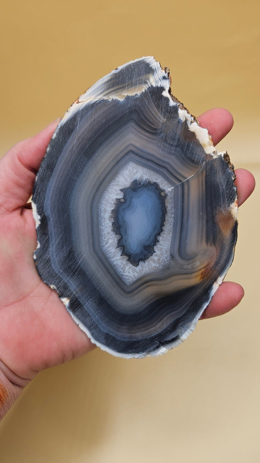 Brazilian Agate slab with dark bullseye pattern, black and gray concentric bands, and a quartz crystal center, 140 grams.