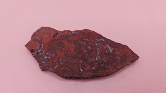 Moss Agate slab 22g, reddish with blue-white moss-like inclusions, 2.6x1.3 inches, photographed on pink background.