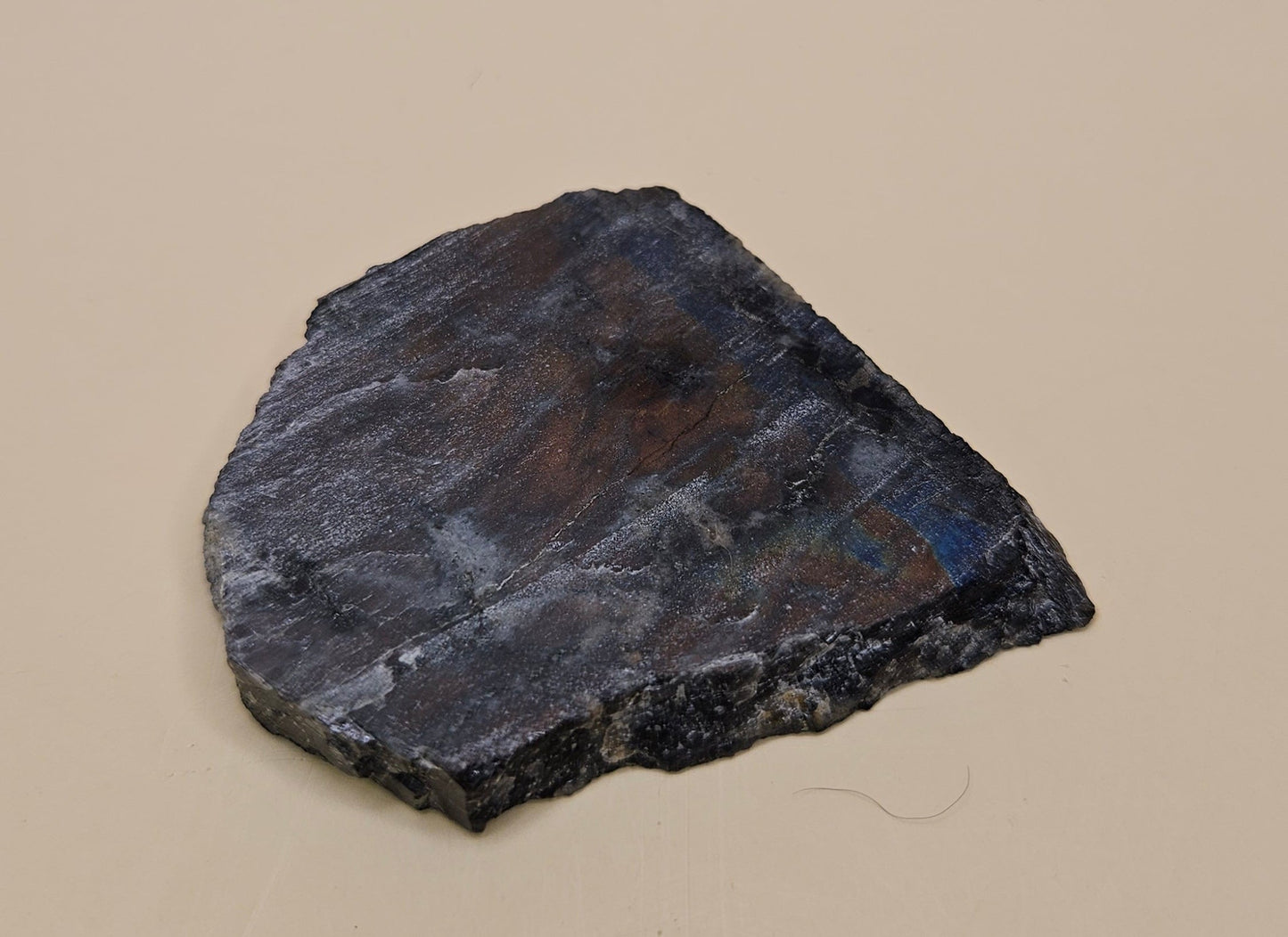 Red Spectrolite slab from Finland showing red and blue flash over dark feldspar base, 36 grams.