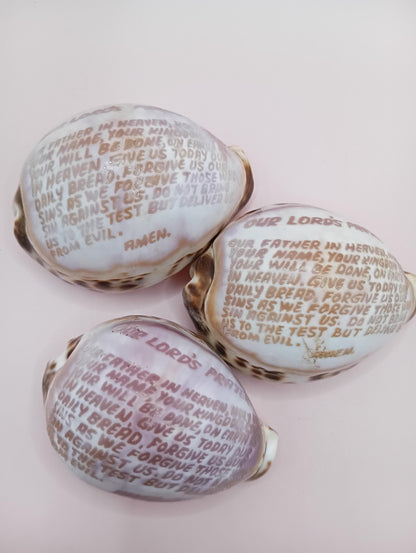 Engraved cowrie shell with "Our Lord's Prayer"