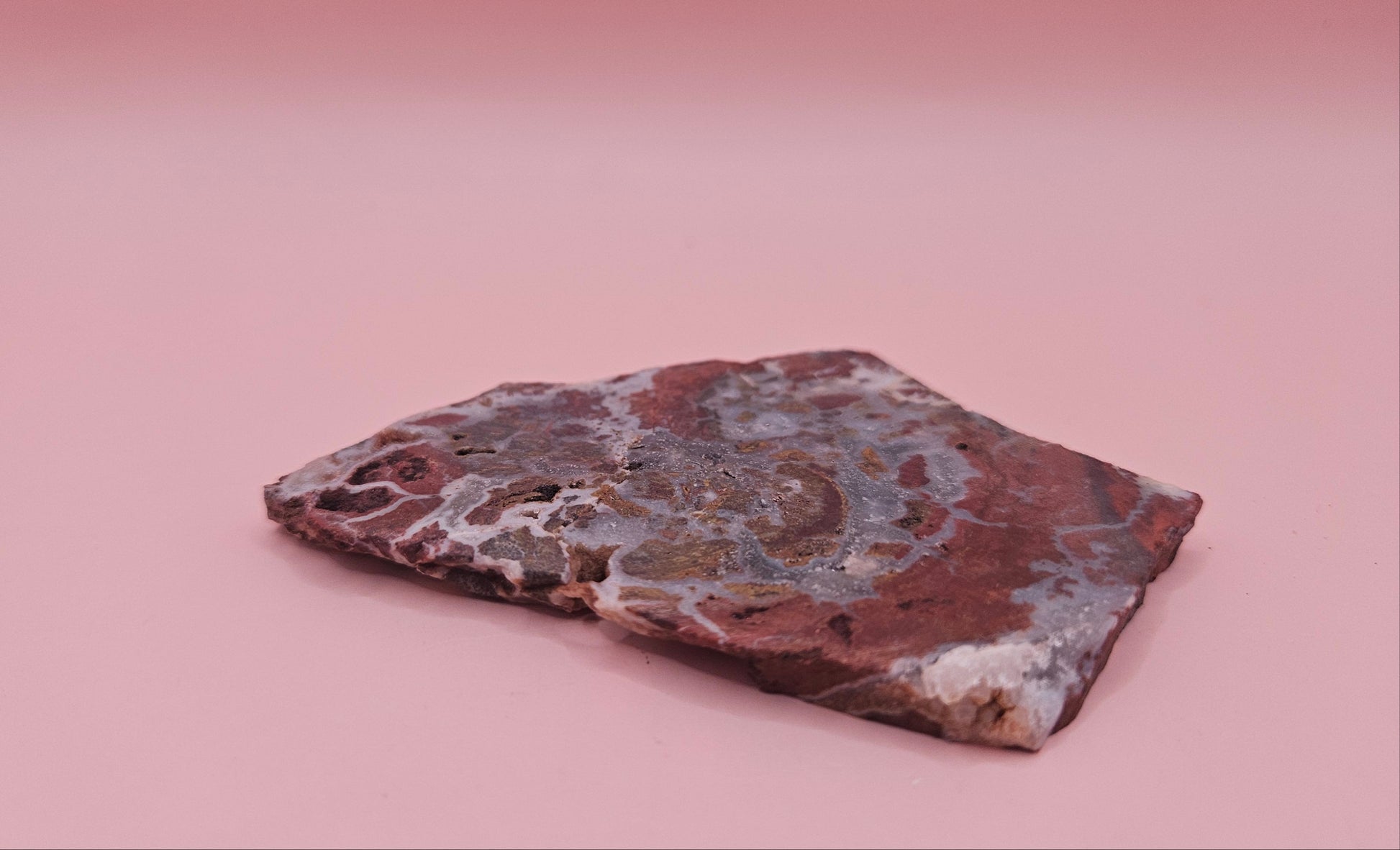 49g Hatch New Mexico rhyolite slab with bold red, tan, and gray brecciated orbicular patterns – ideal for display, lapidary, or crystal collection