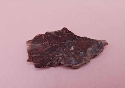 Polished Crazy Lace Agate slab featuring vivid red, gray, tan, and cream swirls with bold banded patterns, 21 grams from Mexico.