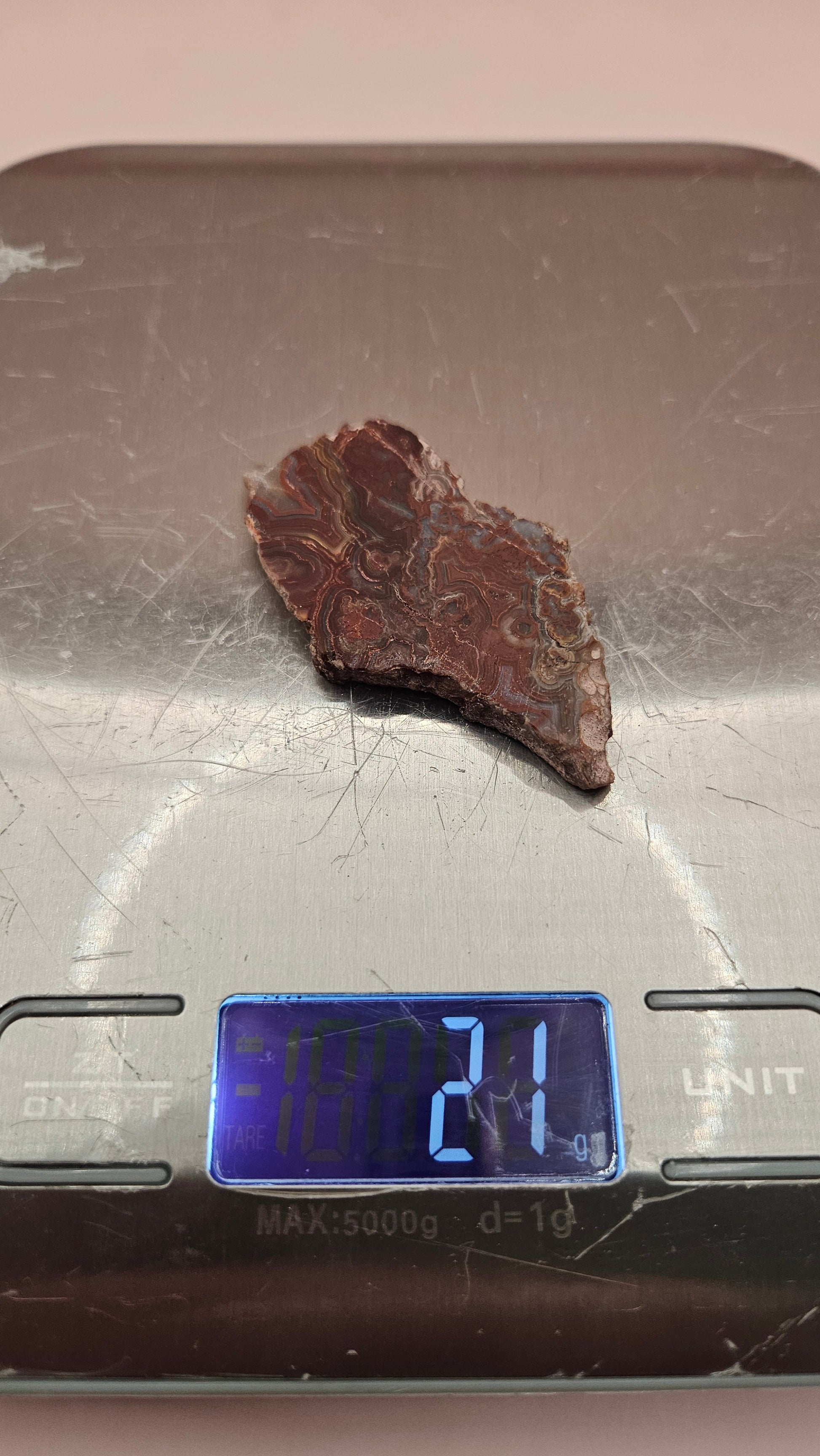 Polished Crazy Lace Agate slab featuring vivid red, gray, tan, and cream swirls with bold banded patterns, 21 grams from Mexico.