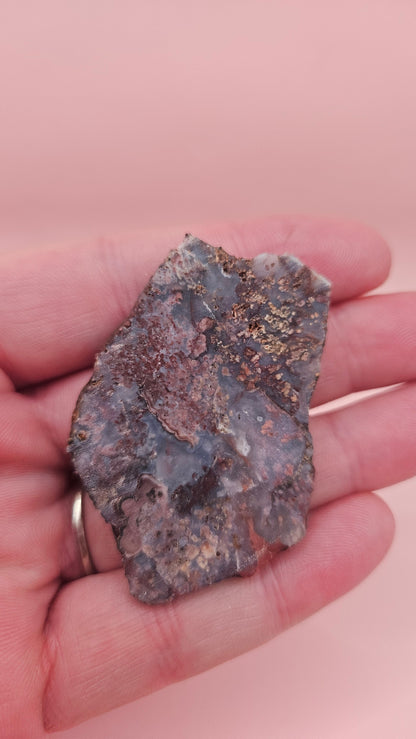 18g Moss Agate slab featuring lavender, gold, and reddish inclusions with rough edges, 2.1x1.4 inches, shown in hand.