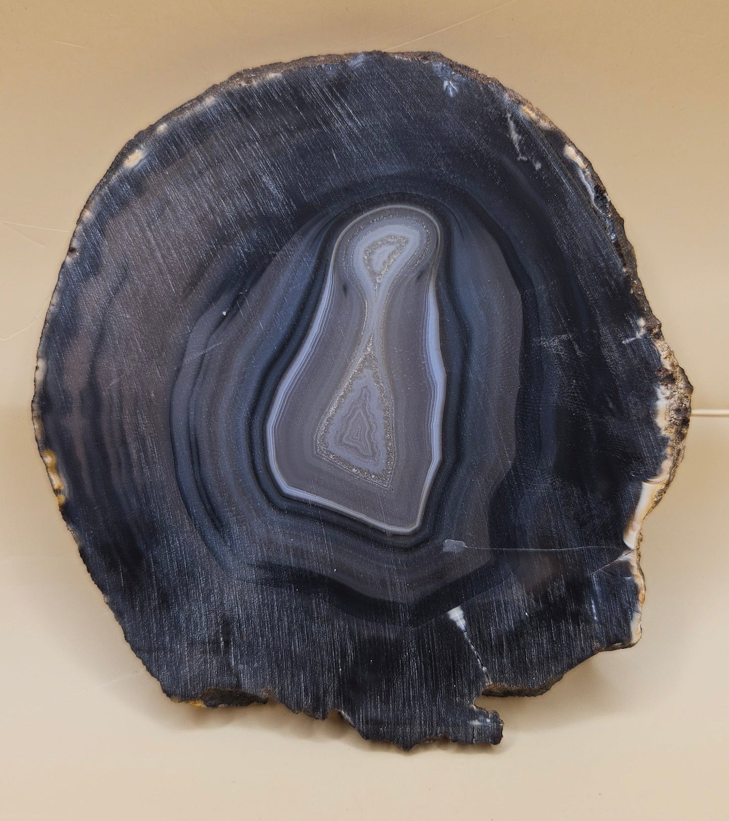Brazilian Agate slab with dark bullseye pattern, black and gray concentric bands, and a quartz crystal center, 140 grams.