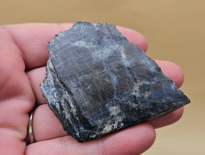 Red Spectrolite slab from Finland  showing red and blue flash over dark feldspar base, 36 grams.
