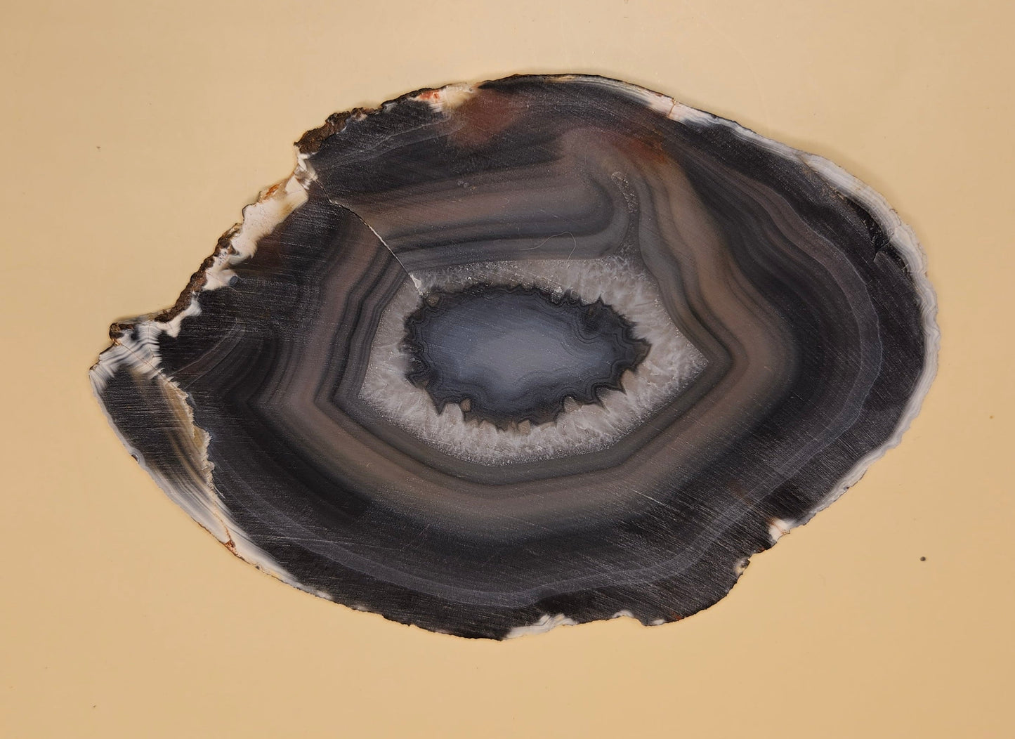Brazilian Agate slab with dark bullseye pattern, black and gray concentric bands, and a quartz crystal center, 140 grams.
