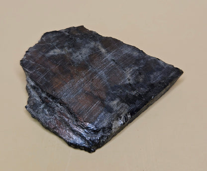 Red Spectrolite slab from Finland  showing red and blue flash over dark feldspar base, 36 grams.