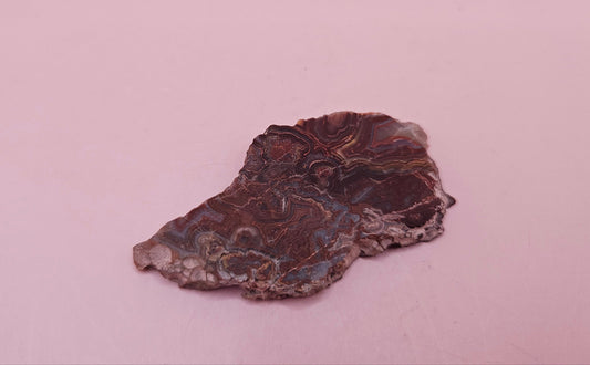 Polished Crazy Lace Agate slab featuring vivid red, gray, tan, and cream swirls with bold banded patterns, 21 grams from Mexico.